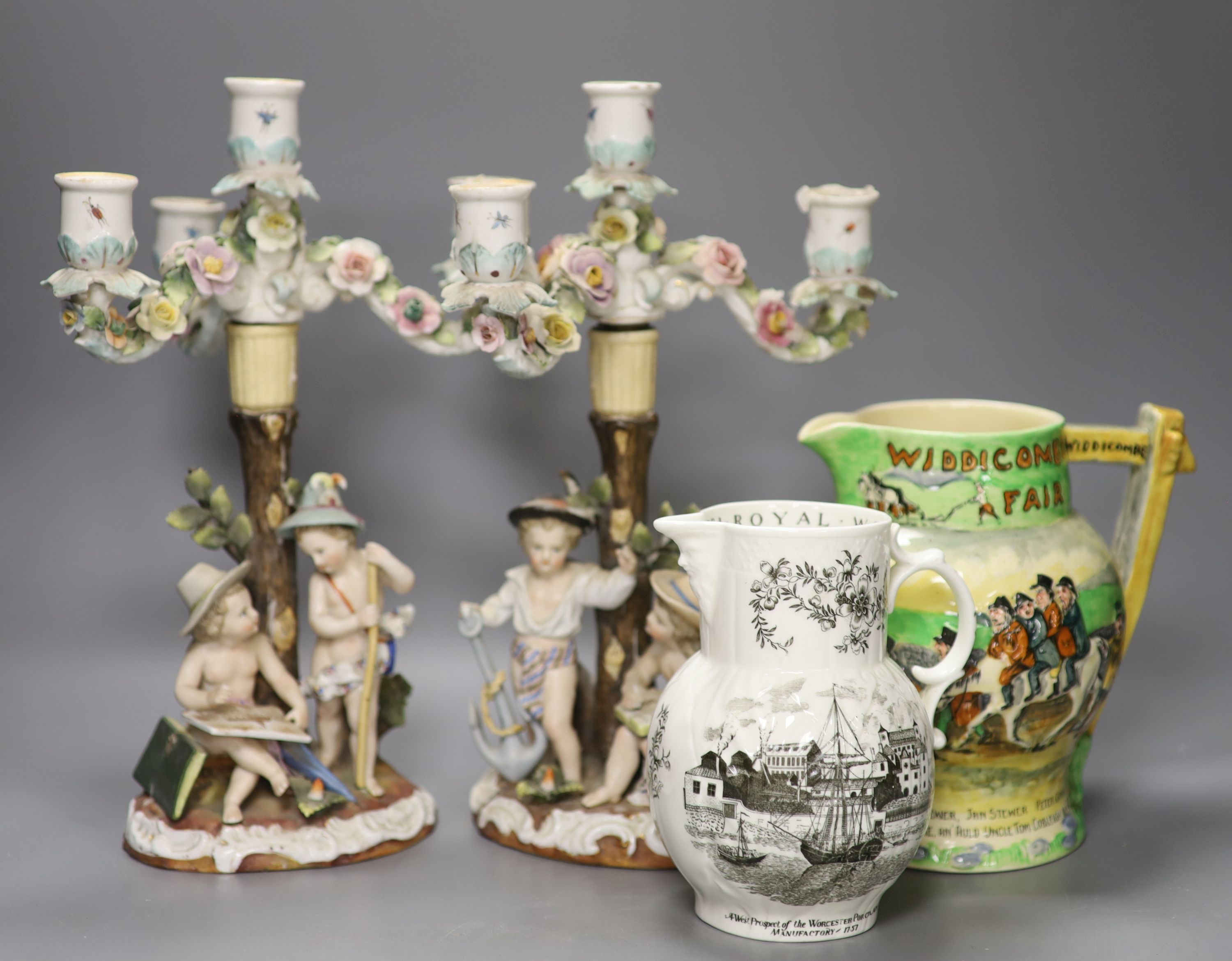 A pair of Continental porcelain floral figural three light candelabra, height 34cm, a Crown Devon Fieldings jug and a Worcester jug